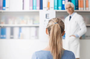 woman in the optometrist office examining her eyesight