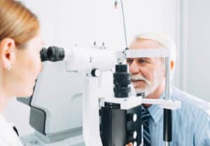 Senior man examined by an ophthalmologist eye exam