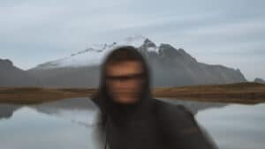 blurred man standing in front of lake and mountain- cataract surgery