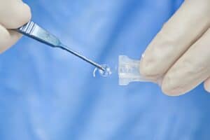 Surgeon prepares IOL for cataract surgery in Loveland, CO