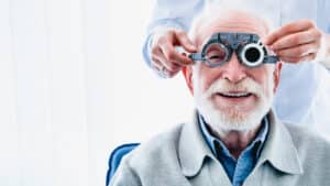 Senior man getting his eyes checked after cataract surgery in Loveland, CO