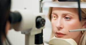 Woman having her eyes examined as part of ophthalmology service in Loveland, CO