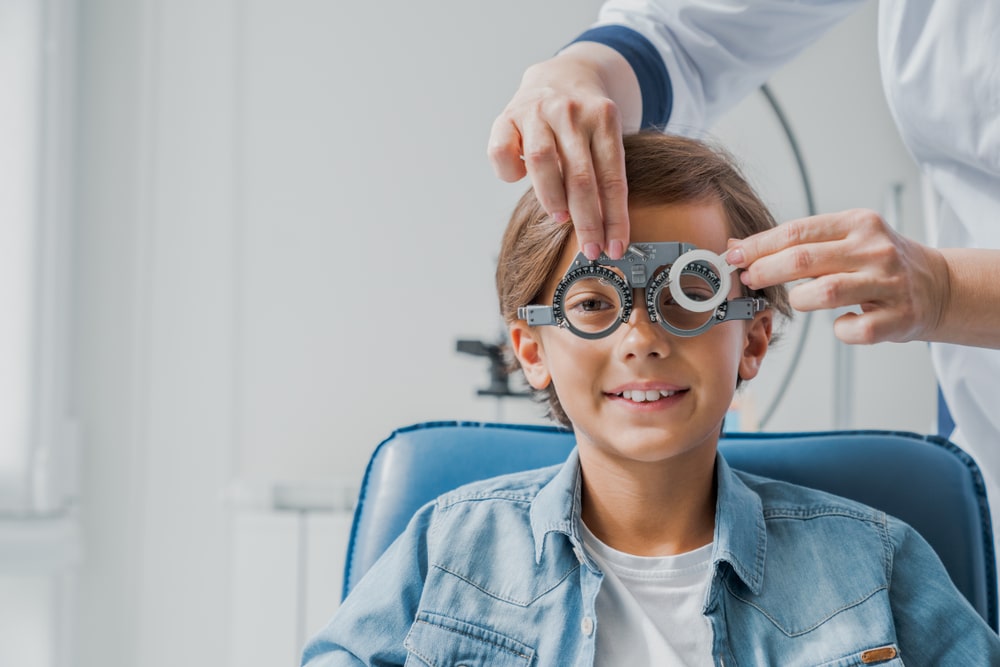 Child at eye doctor being tested for vision issues in Loveland, CO