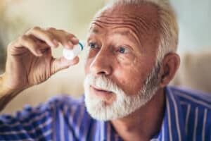Elderly man using eye drops for diabetic retinopathy in Loveland, CA
