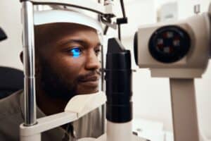 Man getting checked for retinal vein occlusion in Loveland, CO